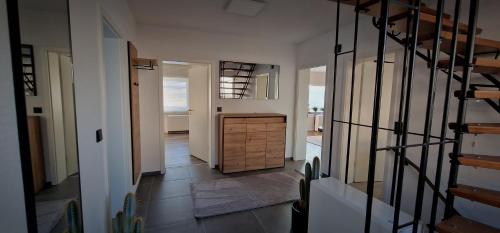 a hallway with a wooden cabinet in a house at Panoramablick in Neunkirchen