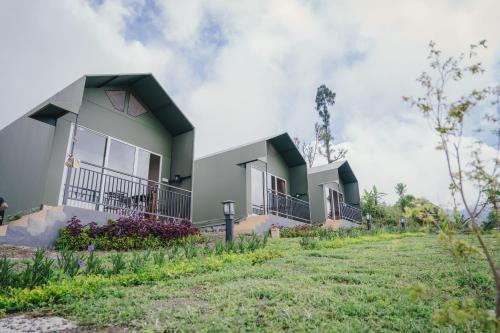 a row of houses on the side of a field at Mesari Hill Glamping in Bedugul