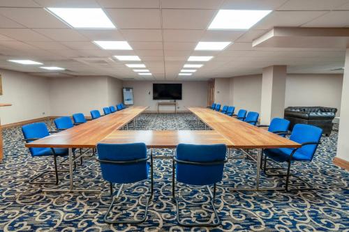 a large conference room with a long table and chairs at Airport Inn & Spa Manchester in Wilmslow