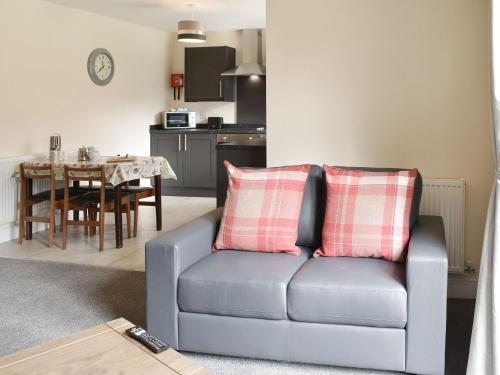 a living room with a couch and a table at Five Dorchester Drive - Uk32043 in Inglewhite