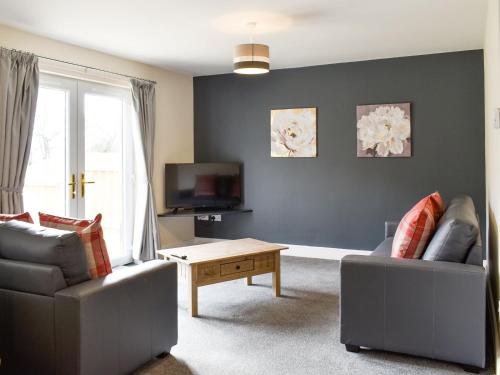 a living room with a couch and a coffee table at Five Dorchester Drive - Uk32043 in Inglewhite