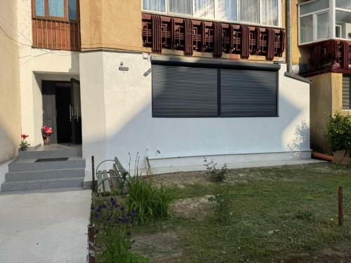 un edificio con una ventana con una puerta. en KUZINATRA Apartament, en Slănic-Moldova