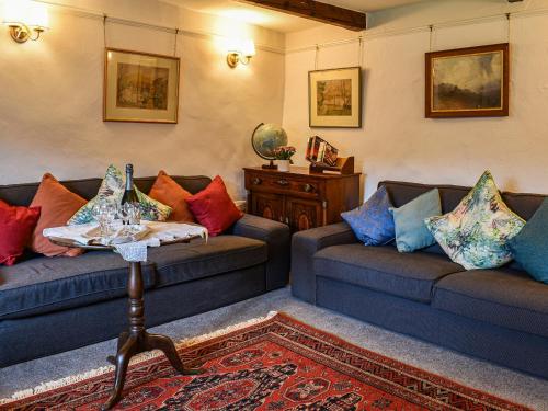 Una sala de estar con dos sofás y una mesa. en Needle House, en Ravenstonedale