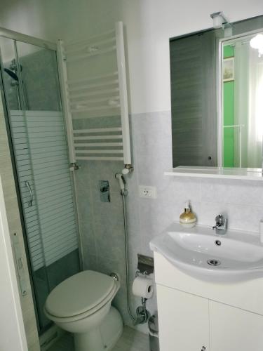 a bathroom with a toilet and a shower and a sink at Mini Room Pero in Pero