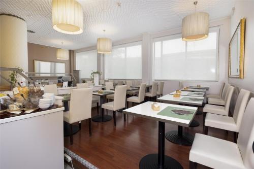 a dining room with tables and white chairs at Best Western Air Hotel Linate in Segrate