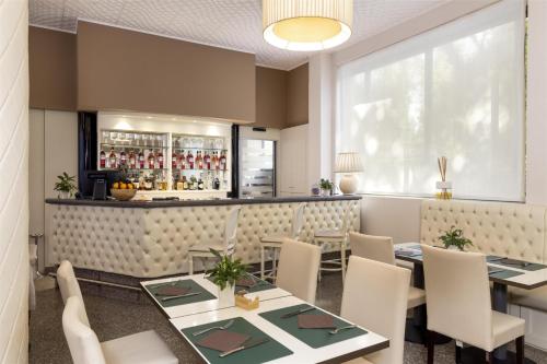 a restaurant with tables and chairs and a bar at Best Western Air Hotel Linate in Segrate