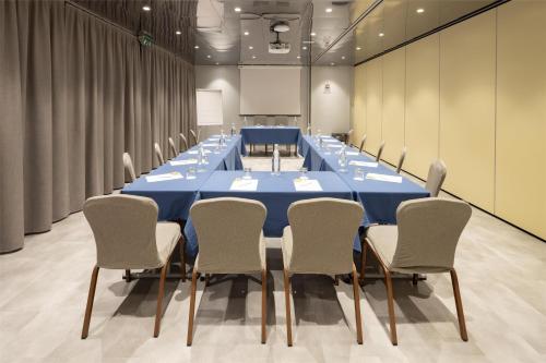 a large conference room with a blue table and chairs at Best Western Air Hotel Linate in Segrate