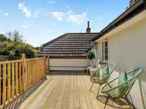 un patio con 2 sillas y una casa en Our House, en Bere Regis