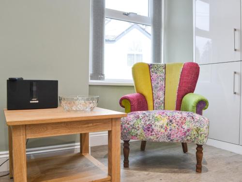 a room with two chairs and a table with a television at 1 Harney Peak in Portinscale