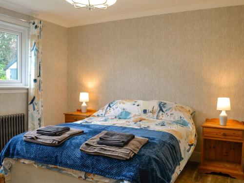 a bedroom with a bed with towels on it at Fyebrae in Stranraer