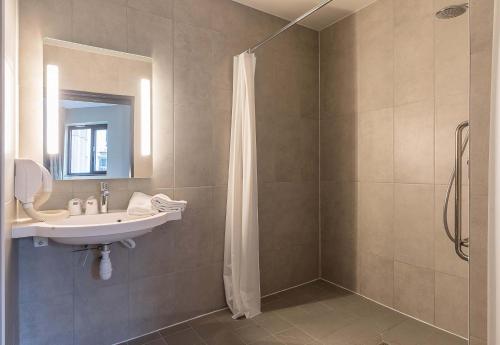 a bathroom with a sink and a shower at B&B HOTEL Rouen Centre Rive Gauche in Rouen