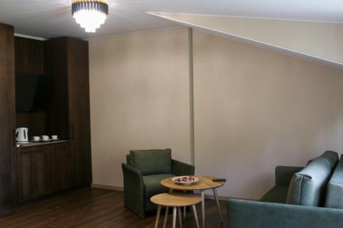 a living room with two chairs and a table at Hotel resort Sedula in Skogalis