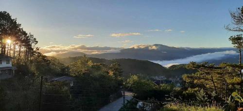 a view of a valley with clouds in the mountains at VidHuset Homestay Sagada in Sagada