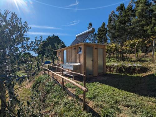 a tiny house on a fence in a field at Quinta Lima in Sertã