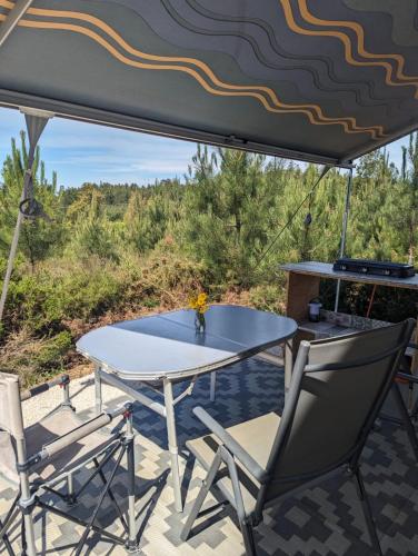 a table and chairs under a tent on a patio at Quinta Lima in Sertã