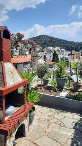 a red bench sitting on top of a roof at Vasilis Garden House in Kavala