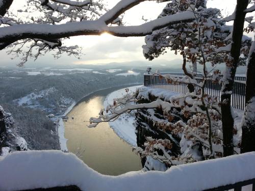 a view of a river covered in snow at Berghotel Bastei in Lohmen