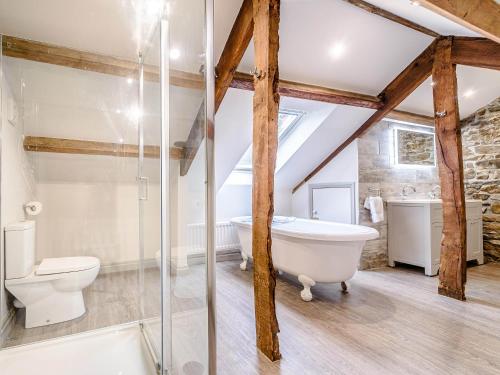 an attic bathroom with a toilet and a bath tub at Ghyll View in Gunnerside