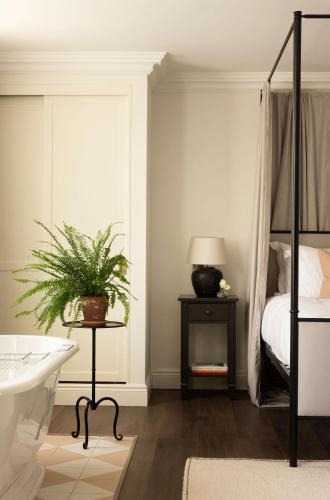 a bedroom with a bed and a plant on a table at Saltmoore in Whitby