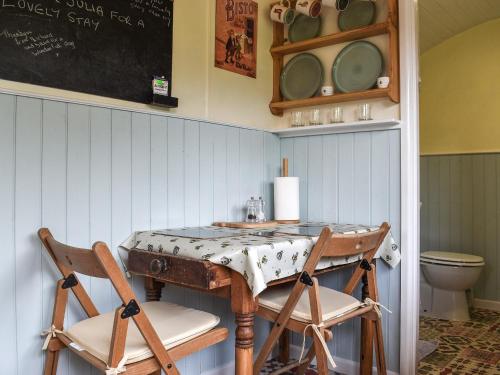 a dining room with a table and two chairs at Field View in St Austell
