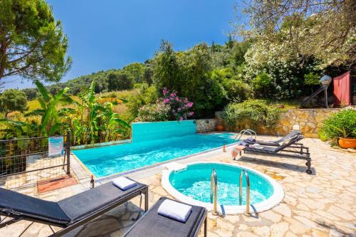 a swimming pool with two lounge chairs and a pool at Villa Poseidonia in Katelios