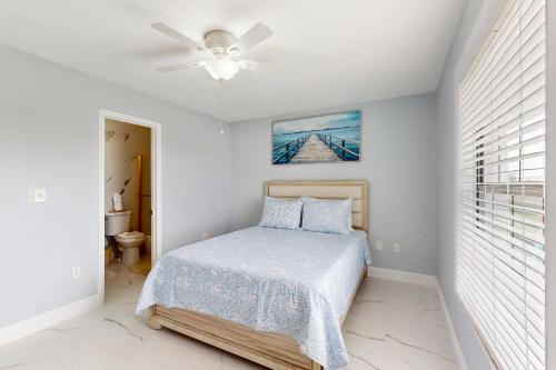 a bedroom with a bed and a ceiling fan at Cozy Paradise in Marco Island
