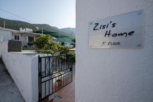 a sign on a building that reads es home if floor at Zisi's Home in Neo Klima