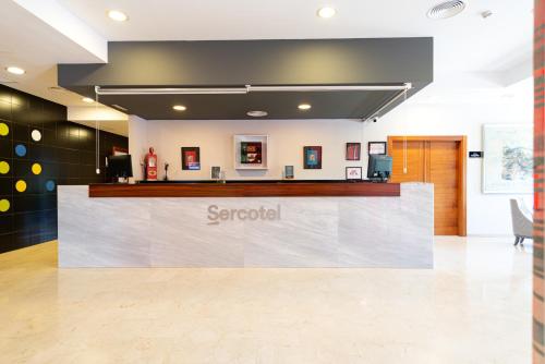 a sign for a scrabili counter in a lobby at Sercotel Riscal in Puerto Lumbreras