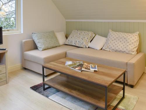 a living room with a couch and a coffee table at Bakers Retreat in Freshwater