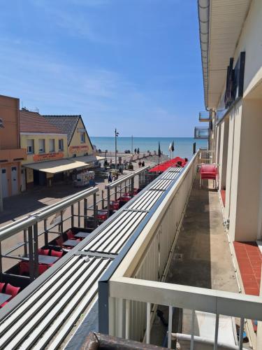 a view of the beach from the balcony of a building at Algues 2 in Quend-Plage