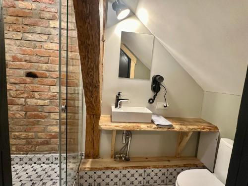 a bathroom with a sink and a glass shower at Svētes klubs 