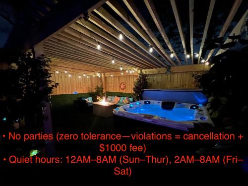 a jacuzzi tub in a backyard at night at Derby City Getaway in Louisville