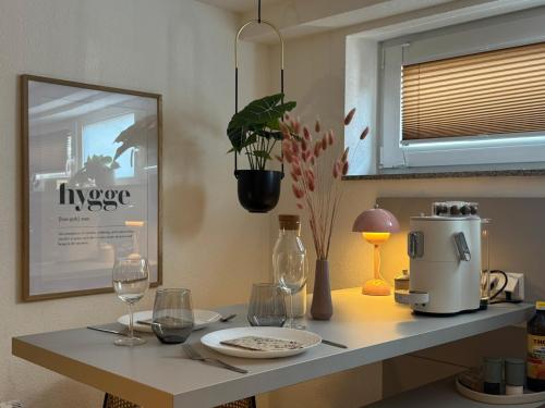 a kitchen counter with a coffee maker and wine glasses at SchwarzwaldQuartier Dobel in Dobel