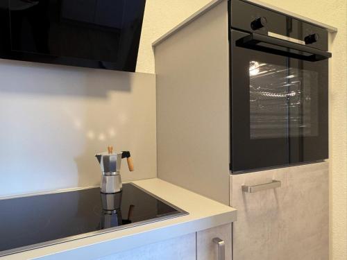 a kitchen with a sink and a coffee pot at SchwarzwaldQuartier Dobel in Dobel
