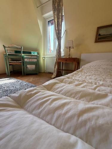 a bedroom with a white bed and a window at Villa Laura in Lausanne