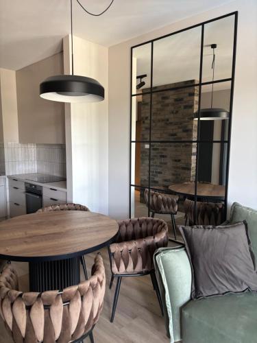 a dining room with a table and chairs at Czarna Perła Hel in Hel