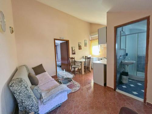 a living room with a couch and a kitchen at Apartmani Relax D in Tivat