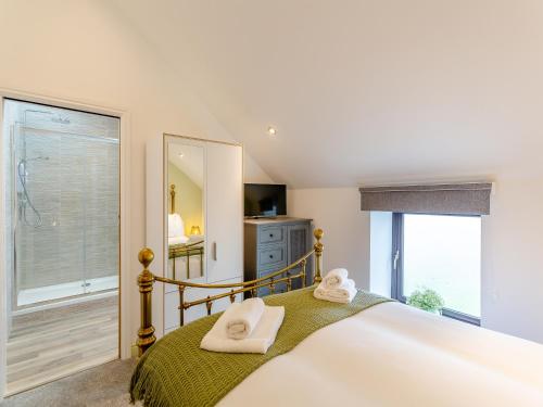 a bedroom with a bed and a large window at Baxter Barn in Carleton