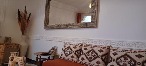 a room with a couch and a mirror on the wall at Riad Kechin Beldi in Marrakech