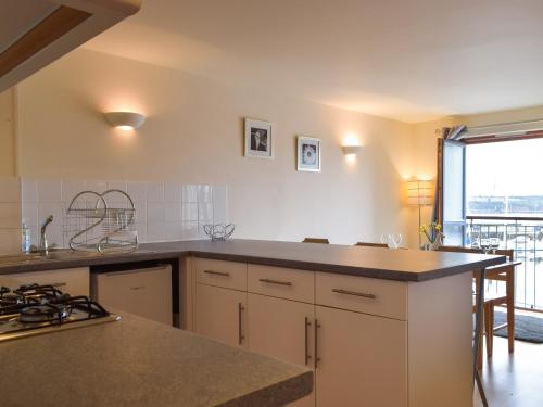 a kitchen with a counter and a large window at Sovereign House in Milford Haven