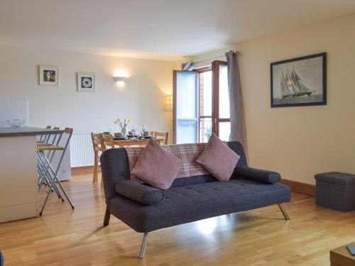 a living room with a couch and a kitchen at Sovereign House in Milford Haven
