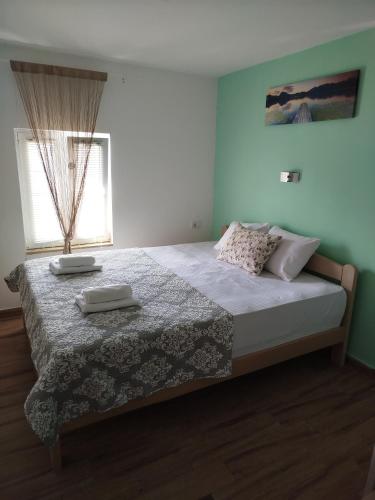 a bedroom with a bed with two towels on it at Serenita Stone House in Becici