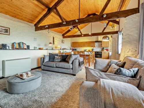 a living room with two couches and a table at 2 Bed in Dulverton 90558 in Dulverton