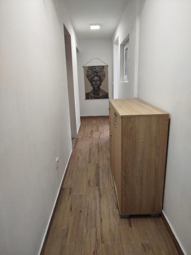 a hallway with a wooden cabinet in a room at Serenita Stone House in Becici