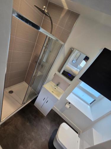 a bathroom with a shower and a toilet and a sink at Taigh Mor in Elgin