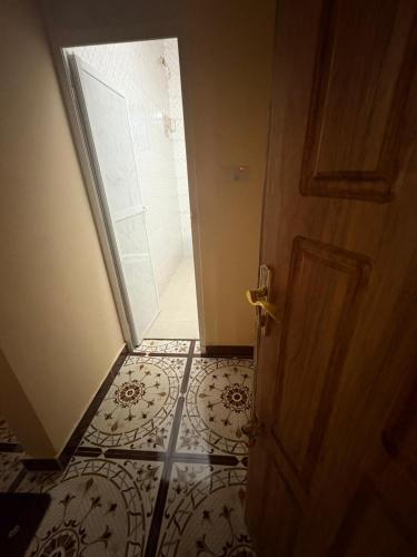 an open door to a bathroom with a shower at ZanziBalkan House Nungwi in Nungwi