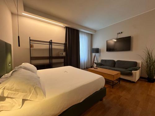 a hotel room with a bed and a couch at Il Lavatoio Dimora Storica in Castel di Sangro
