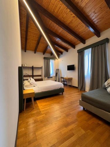 a bedroom with two beds and a wooden floor at Il Lavatoio Dimora Storica in Castel di Sangro