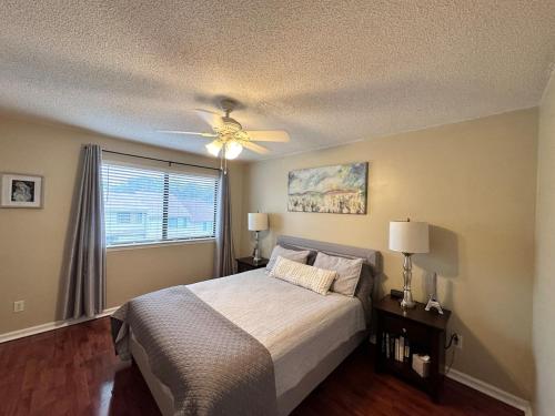 a bedroom with a bed and a ceiling fan at Sunny Large Two Bedroom Townhouse - Pool in Pensacola