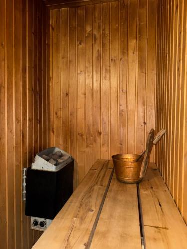 a wooden table with a bowl and a box at Eha Farmstay in Rõuge
